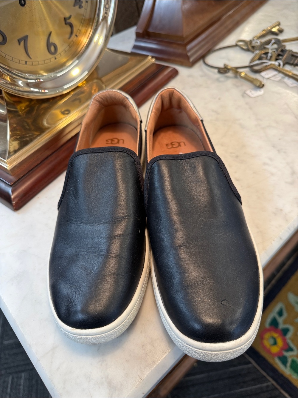 UGG women’s Black Leather Slip-On Loafers with White Sole